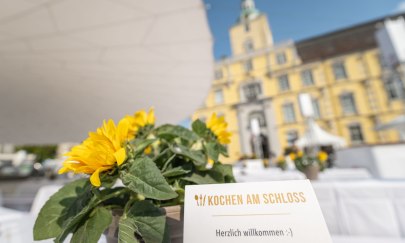 Bei Kochen am Schloss werden auf dem Oldenburger Schlossplatz lange Tischreihen eingedeckt.