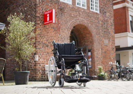 Ein Rollstuhl vor der Touristinfo Oldenburg, wo dieser entliehen werden kann.